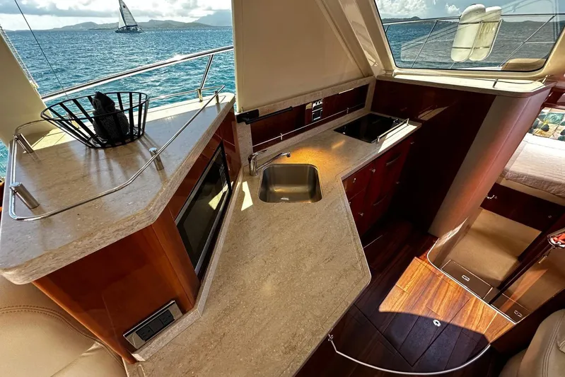  Yacht Photos Pics Luxurious interior of 2012 Riviera 43 Flybridge yacht with modern kitchen and ocean view.