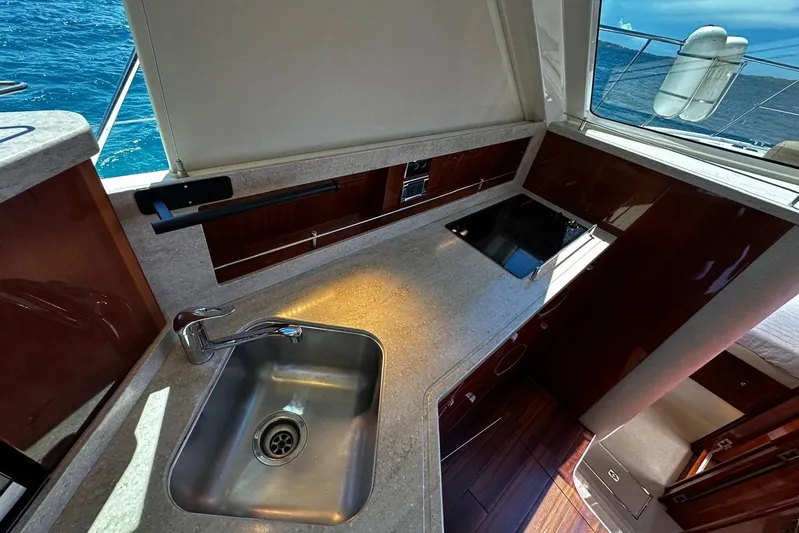  Yacht Photos Pics Interior of 2012 Riviera 43 Flybridge yacht with modern kitchen and ocean view.