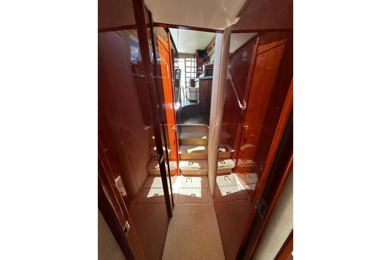  Yacht Photos Pics Interior hallway of 2012 Riviera 43 Flybridge yacht with polished wood finish.