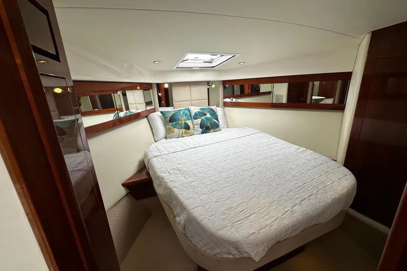  Yacht Photos Pics Luxurious bedroom interior of 2012 Riviera 43 Flybridge yacht with elegant bedding and mirrors.