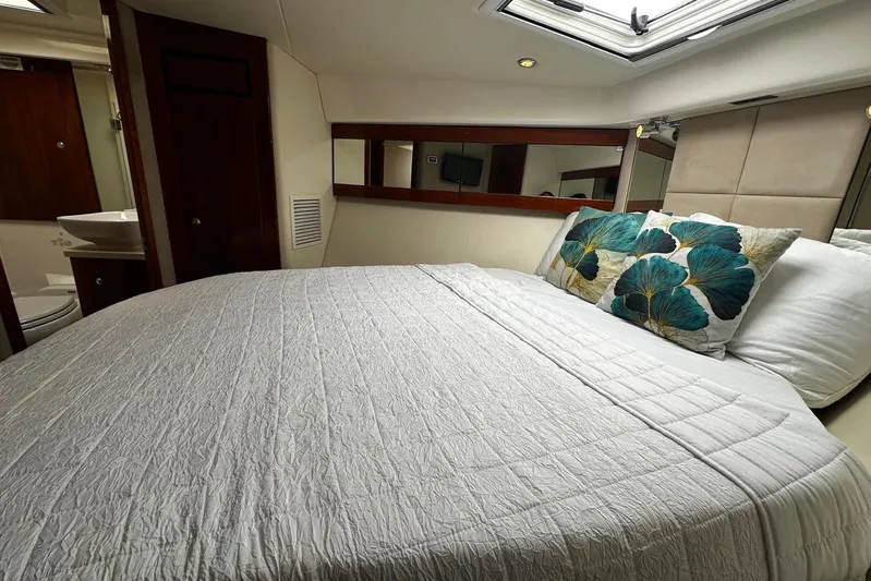  Yacht Photos Pics Luxurious bedroom interior of 2012 Riviera 43 Flybridge yacht with elegant bedding.