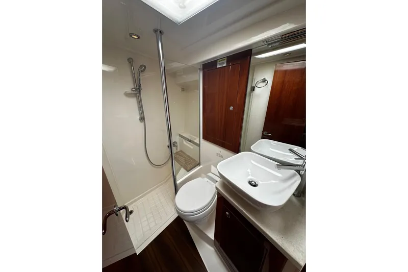  Yacht Photos Pics Luxurious bathroom in 2012 Riviera 43 Flybridge yacht with modern fixtures and elegant wood accents.