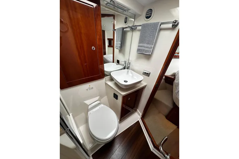  Yacht Photos Pics Luxurious bathroom in 2012 Riviera 43 Flybridge yacht with modern fixtures and wood accents.