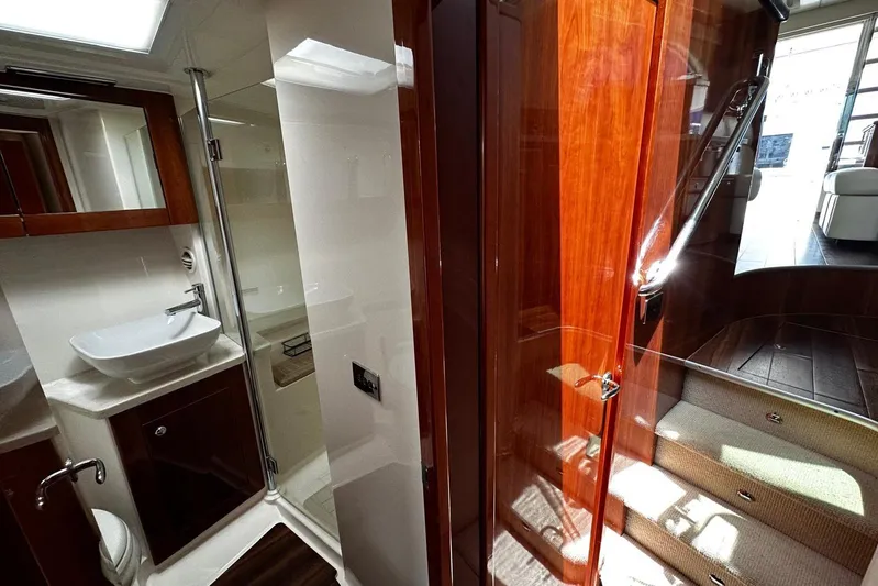  Yacht Photos Pics Luxurious 2012 Riviera 43 Flybridge yacht interior with modern bathroom and elegant wood finishes.