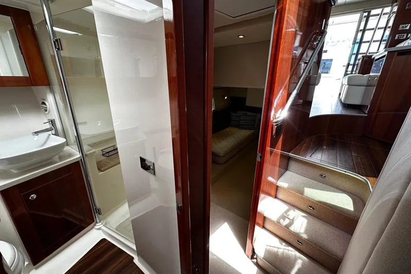  Yacht Photos Pics Luxurious interior of 2012 Riviera 43 Flybridge yacht with elegant wood finishes.