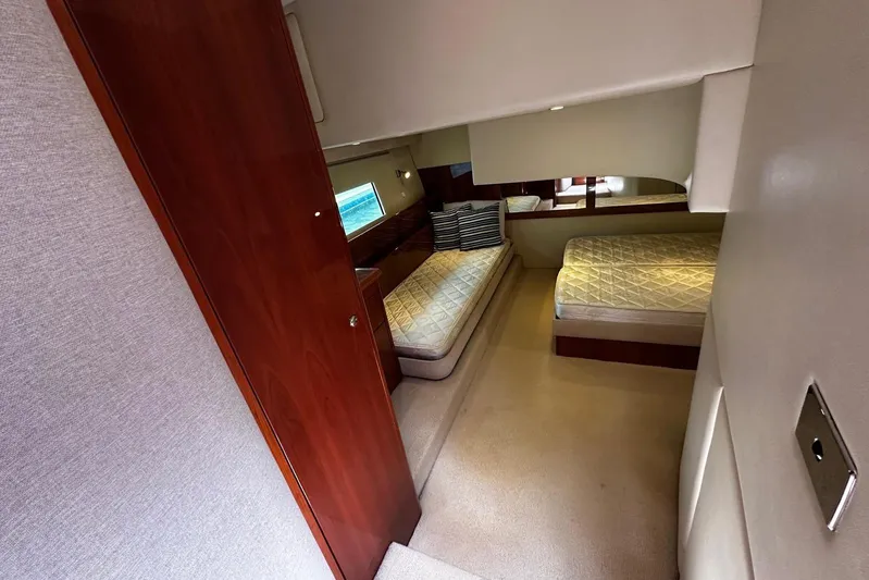 Yacht Photos Pics Interior of 2012 Riviera 43 Flybridge yacht with twin beds and wooden accents.