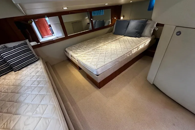  Yacht Photos Pics Interior of 2012 Riviera 43 Flybridge yacht with cozy twin beds and elegant decor.