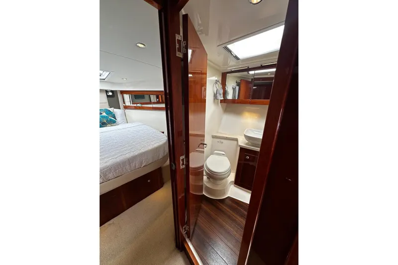  Yacht Photos Pics Luxurious interior of 2012 Riviera 43 Flybridge yacht with bedroom and bathroom.