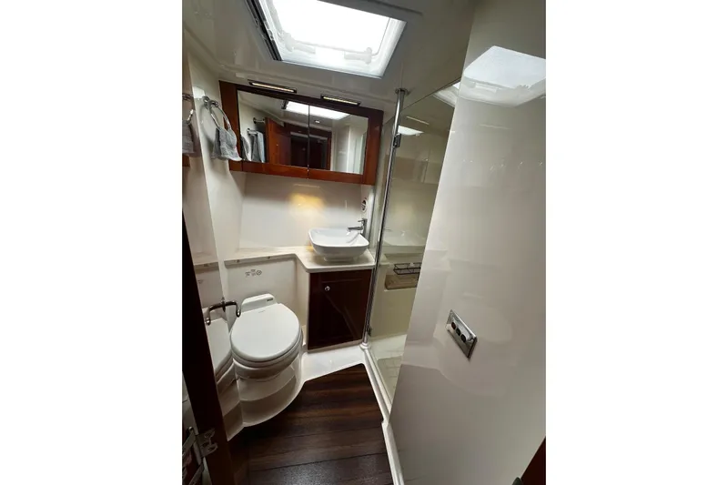  Yacht Photos Pics Luxurious bathroom in 2012 Riviera 43 Flybridge yacht with modern fixtures and wood accents.