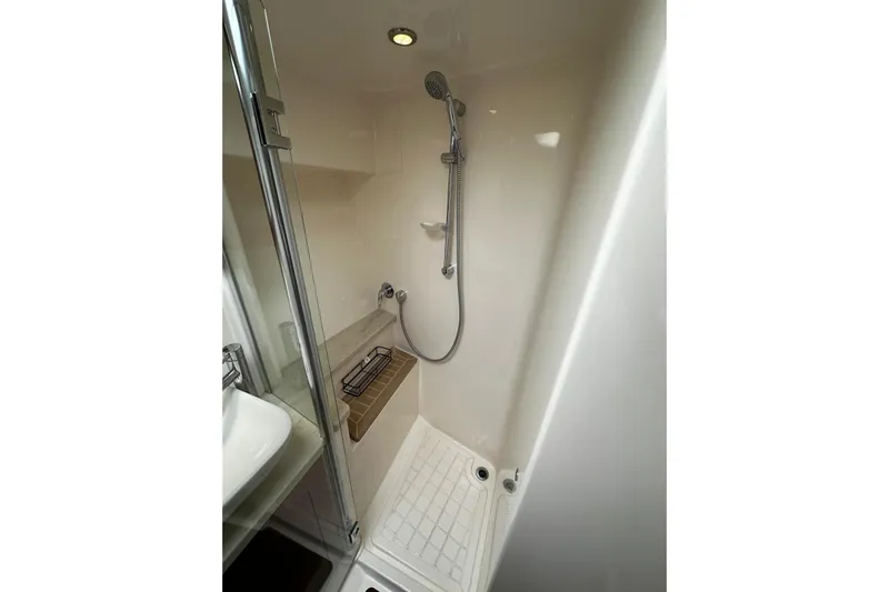  Yacht Photos Pics Compact shower area in 2012 Riviera 43 Flybridge yacht, featuring modern fixtures and glass door.