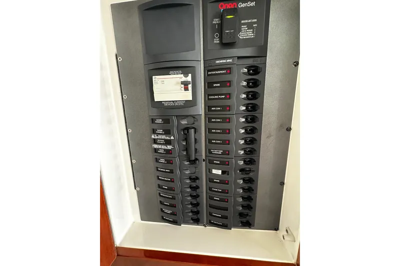  Yacht Photos Pics Electrical panel on a 2012 Riviera 43 Flybridge boat, featuring Onan GenSet controls.
