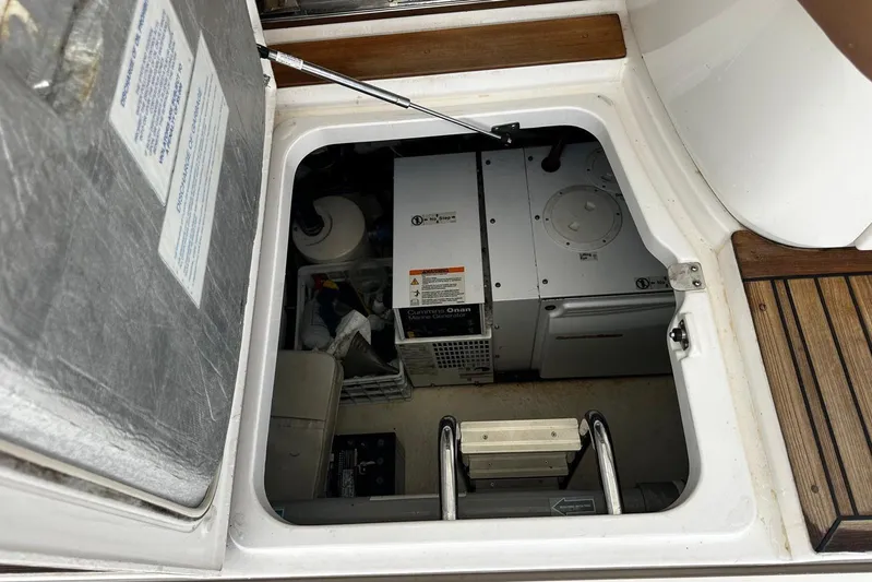  Yacht Photos Pics Engine compartment of 2012 Riviera 43 Flybridge yacht, showcasing equipment and storage.