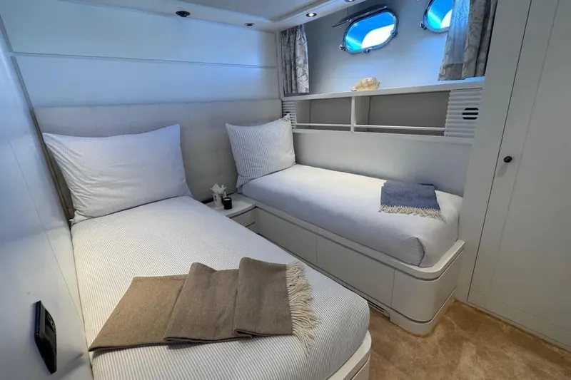  Yacht Photos Pics Twin cabin interior of 2000 Sanlorenzo SL88 yacht, featuring cozy beds and porthole windows.