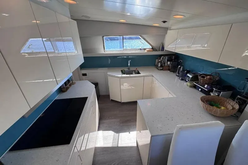  Yacht Photos Pics Luxurious kitchen interior of 2000 Sanlorenzo SL88 yacht with modern appliances and sleek design.