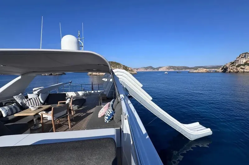  Yacht Photos Pics Luxurious Sanlorenzo SL88 yacht with slide, 2000 model, anchored in serene blue waters.