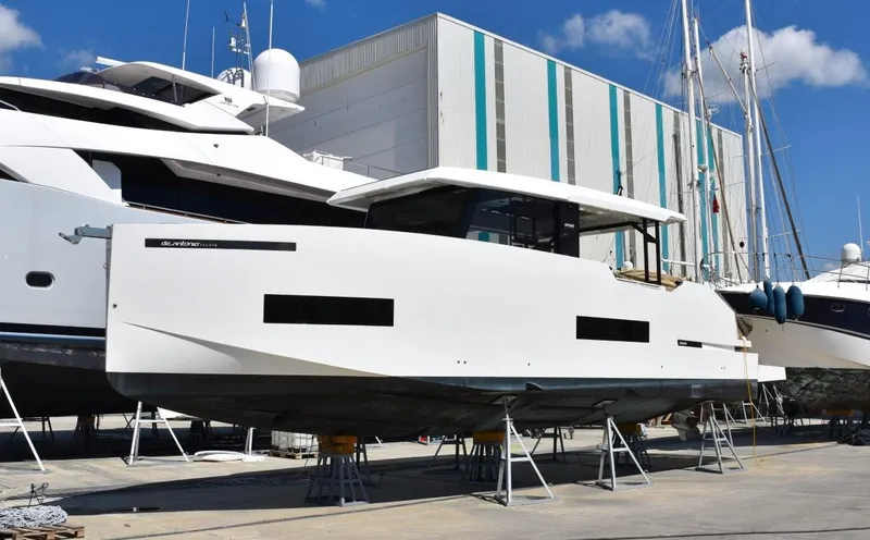  Yacht Photos Pics 2024 De Antonio Yachts D50 on dry dock, showcasing sleek design and modern features.