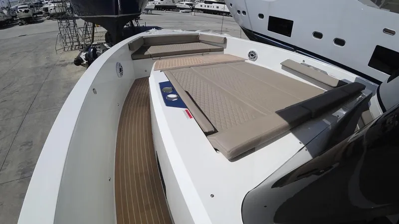  Yacht Photos Pics 2024 De Antonio Yachts D50 deck with cushioned seating and sleek design.
