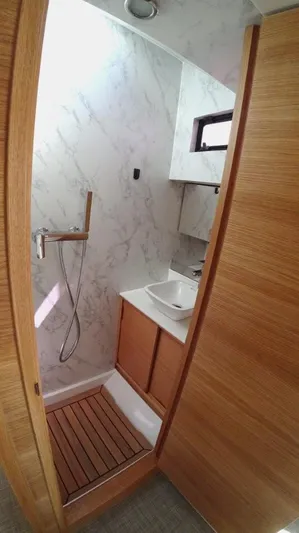  Yacht Photos Pics 2024 De Antonio Yachts D50 bathroom with modern fixtures and wood accents.