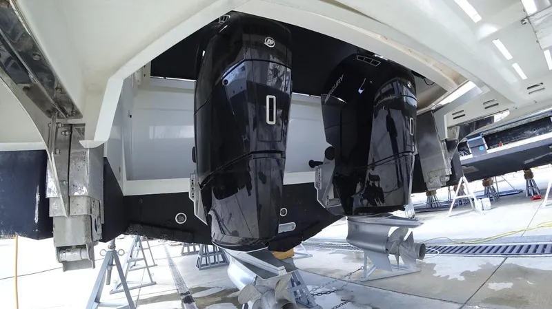  Yacht Photos Pics 2024 De Antonio Yachts D50 with dual outboard engines, displayed on a boat stand.