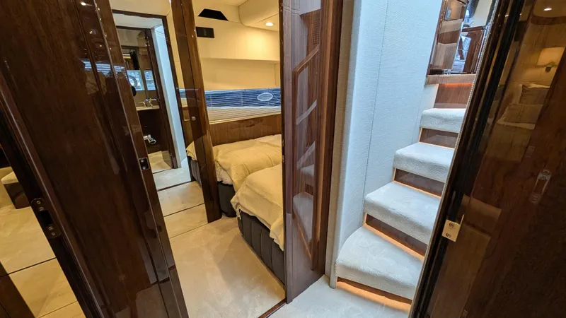 New 2025 Model Yacht Photos Pics Luxurious interior of 2025 Fairline Squadron 58 yacht with elegant wood finishes and cozy bedrooms.