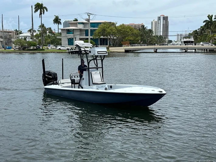  Yacht Photos Pics 2019 Yellowfin 24 Bay CE boat on a calm urban waterway.