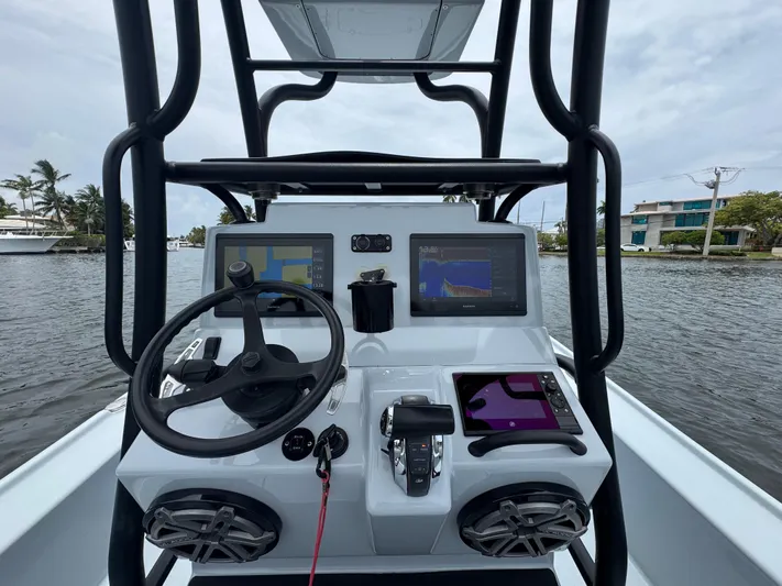  Yacht Photos Pics 2019 Yellowfin 24 Bay CE boat dashboard with steering wheel and navigation screens.