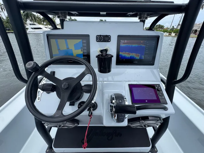  Yacht Photos Pics 2019 Yellowfin 24 Bay CE boat dashboard with navigation screens and steering wheel.