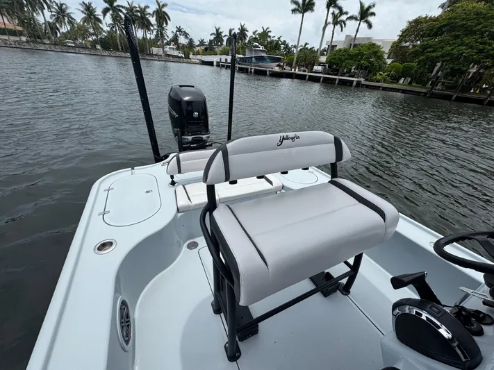  Yacht Photos Pics 2019 Yellowfin 24 Bay CE boat with seating, motor, and waterway view.