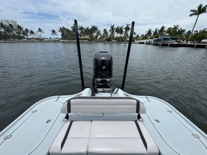  Yacht Photos Pics 2019 Yellowfin 24 Bay CE boat on calm water with palm trees in background.