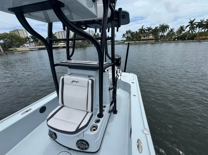  Yacht Photos Pics 2019 Yellowfin 24 Bay CE boat on calm water with palm trees in the background.