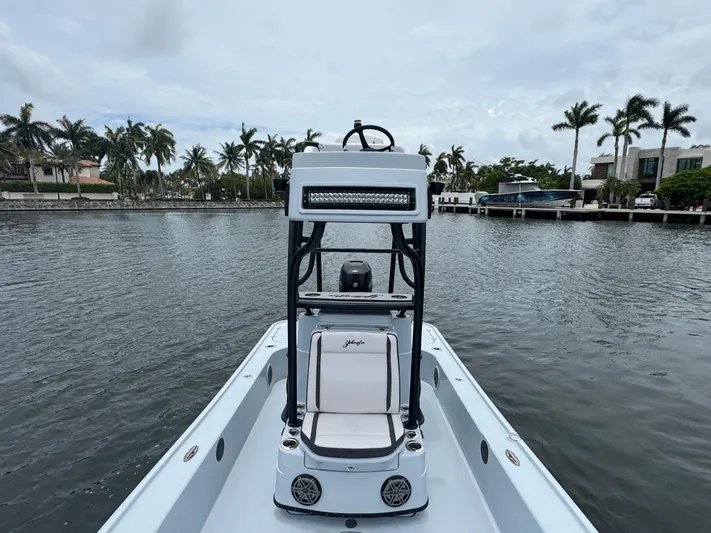  Yacht Photos Pics 2019 Yellowfin 24 Bay CE boat on calm water, surrounded by palm trees.