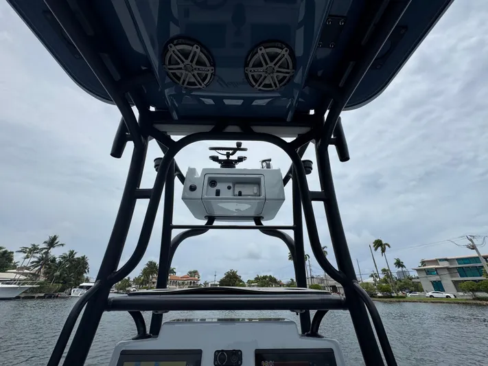  Yacht Photos Pics 2019 Yellowfin 24 Bay CE boat console with speakers, on a cloudy day.