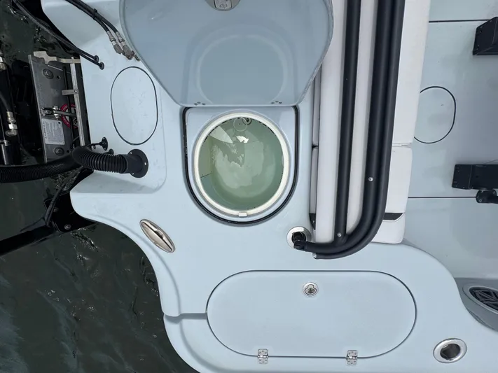  Yacht Photos Pics 2019 Yellowfin 24 Bay CE boat deck with livewell and storage compartments.