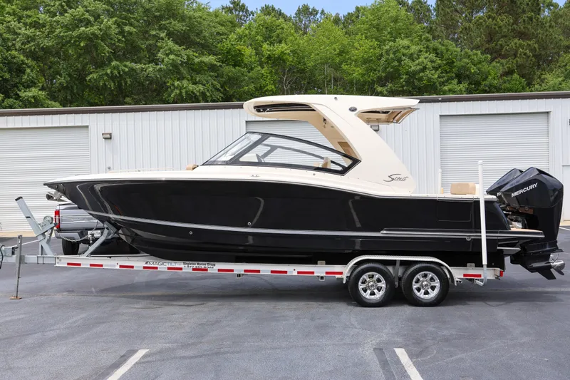  Yacht Photos Pics 2022 Scout 277 Dorado boat on trailer, parked outdoors.