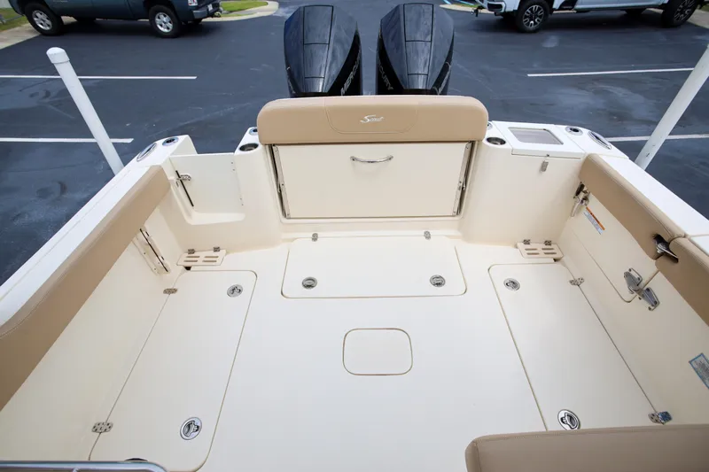  Yacht Photos Pics 2022 Scout 277 Dorado boat interior with beige seating and storage compartments.