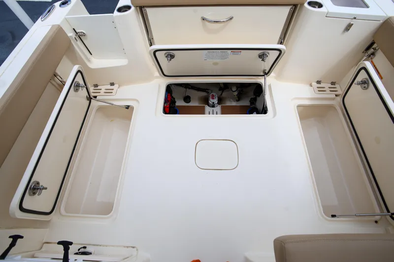  Yacht Photos Pics 2022 Scout 277 Dorado boat interior with open storage compartments.