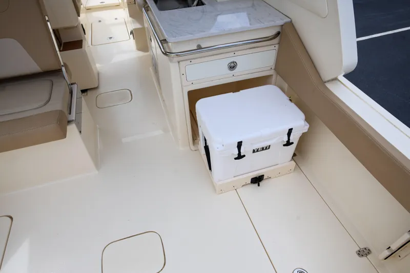  Yacht Photos Pics 2022 Scout 277 Dorado boat interior with seating, cooler, and sink area.