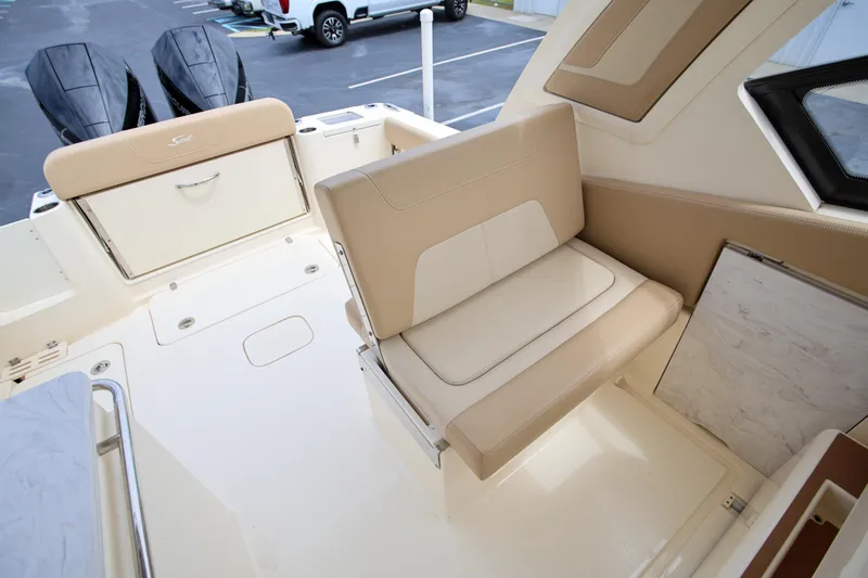  Yacht Photos Pics 2022 Scout 277 Dorado boat interior with beige seating and storage compartments.