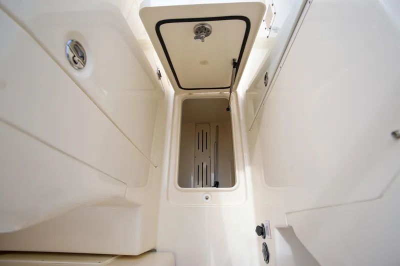  Yacht Photos Pics 2022 Scout 277 Dorado boat storage compartment with open hatch, showcasing interior space.