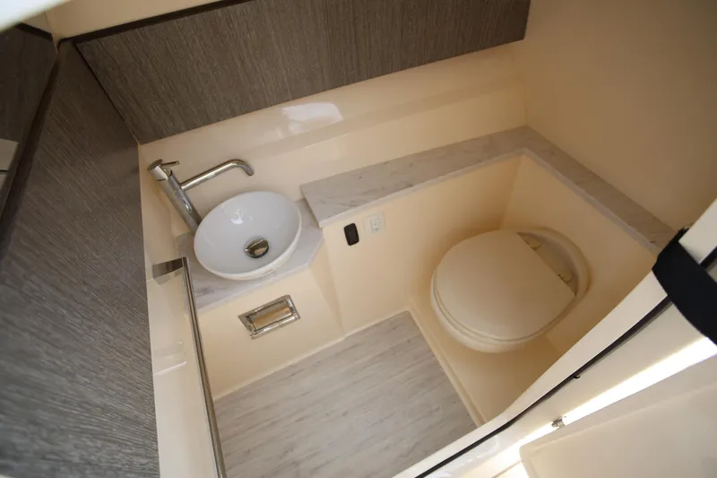  Yacht Photos Pics 2022 Scout 277 Dorado boat bathroom with sink and toilet, modern design.