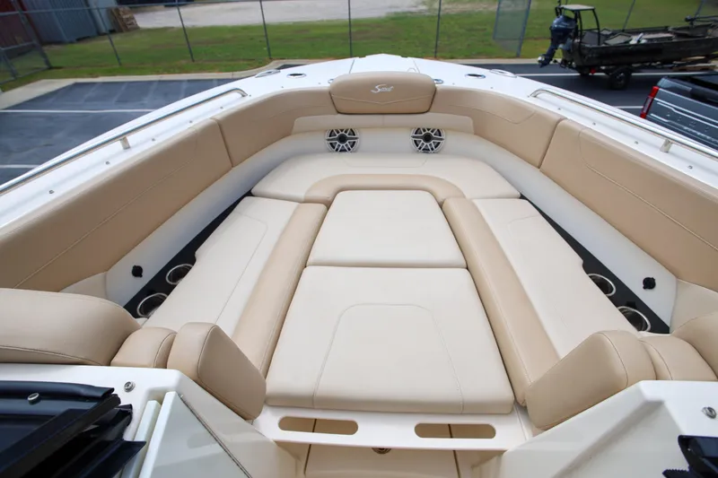  Yacht Photos Pics 2022 Scout 277 Dorado boat interior with beige seating and cup holders.
