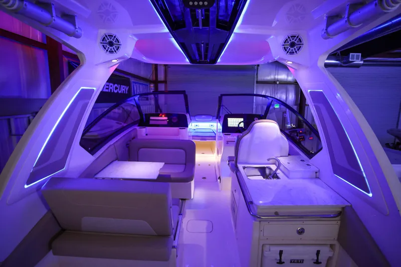  Yacht Photos Pics 2022 Scout 277 Dorado boat interior with modern lighting and seating arrangement.
