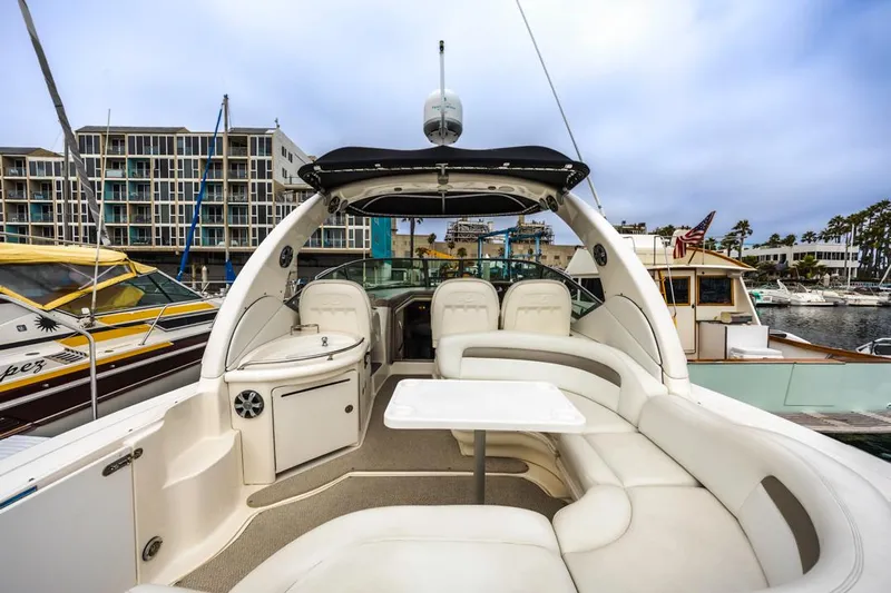 Good Kitty Yacht Photos Pics 2006 Sea Ray 340 Sundancer yacht interior with seating and table, docked in a marina.