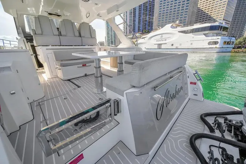  Yacht Photos Pics 2020 Azimut Verve 40 yacht interior with modern seating and table, docked near luxury boats.