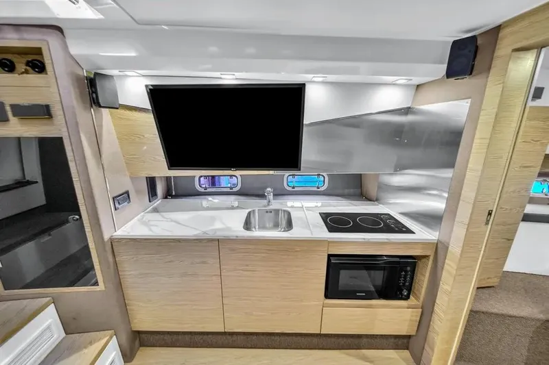  Yacht Photos Pics Modern kitchen interior of 2020 Azimut Verve 40 yacht with sleek appliances and wood finish.