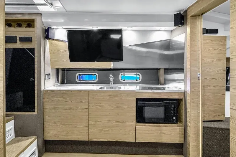  Yacht Photos Pics Modern kitchen interior of 2020 Azimut Verve 40 yacht with wood cabinetry and appliances.