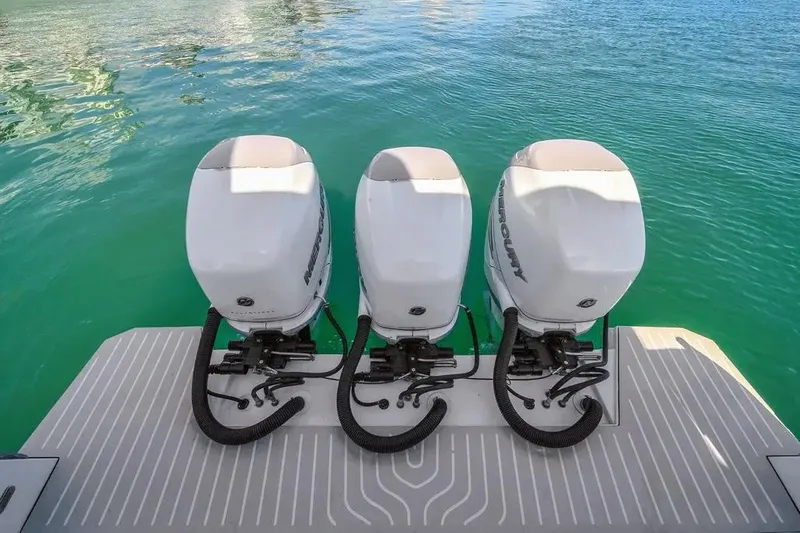  Yacht Photos Pics Triple outboard motors on a 2020 Azimut Verve 40 yacht, floating on clear turquoise water.