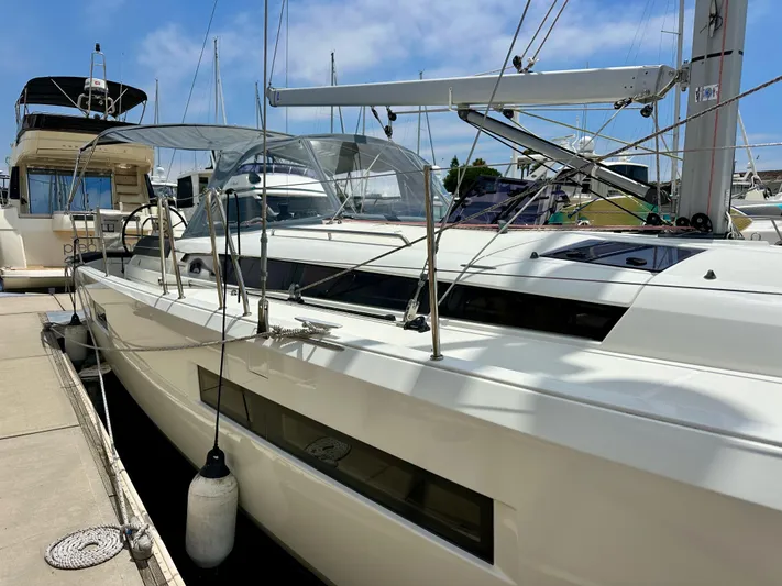 Kemosabe Yacht Photos Pics Jeanneau Sun Odyssey 440 sailboat, 2021 model, docked at marina under clear sky.