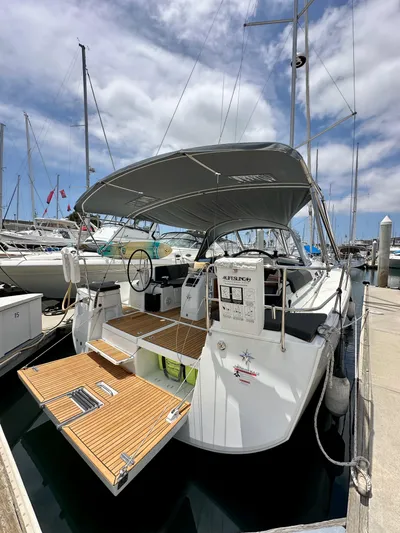 Kemosabe Yacht Photos Pics 2021 Jeanneau Sun Odyssey 440 sailboat docked at marina under cloudy sky.