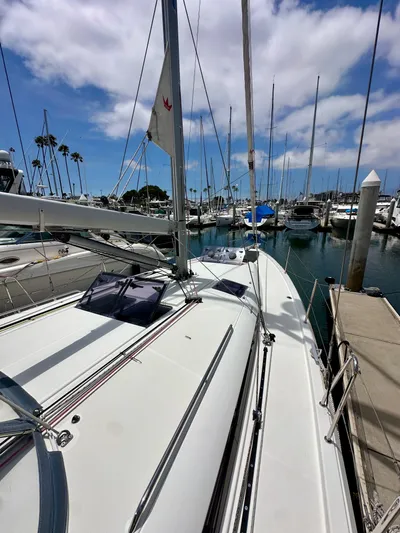 Kemosabe Yacht Photos Pics Sailboat Jeanneau Sun Odyssey 440, 2021 model, docked in a marina under a blue sky.